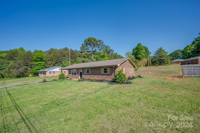 ranch-style house with a front lawn