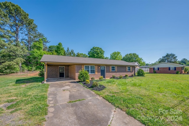 ranch-style house with a carport and a front lawn