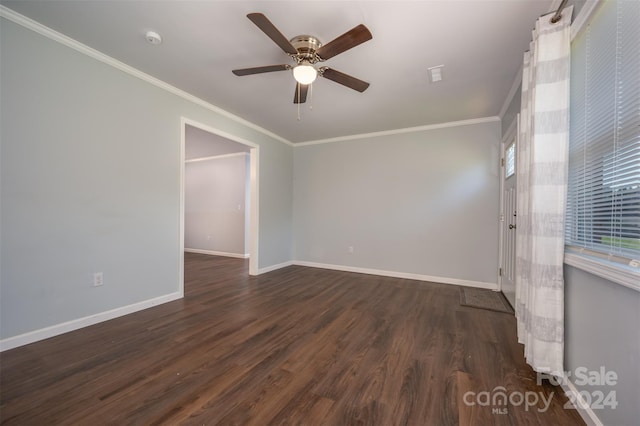 unfurnished room featuring dark wood-type flooring, crown molding, and ceiling fan