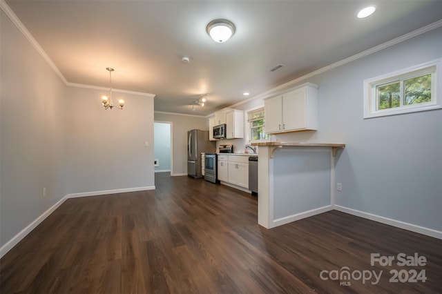 kitchen with appliances with stainless steel finishes, dark wood-type flooring, crown molding, white cabinetry, and kitchen peninsula