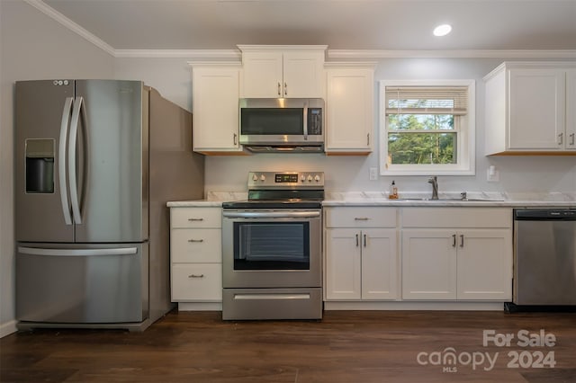 kitchen with dark hardwood / wood-style flooring, sink, appliances with stainless steel finishes, white cabinets, and crown molding