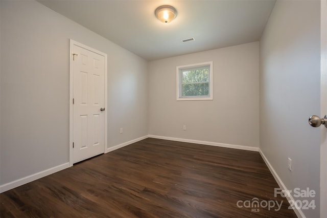 empty room with dark wood-type flooring