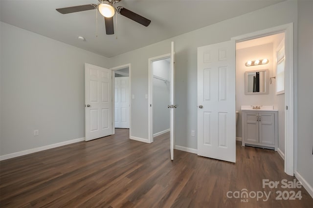 unfurnished bedroom featuring connected bathroom, ceiling fan, dark hardwood / wood-style flooring, and sink