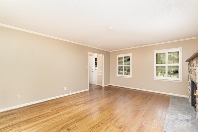 interior space with a fireplace, crown molding, and light hardwood / wood-style floors