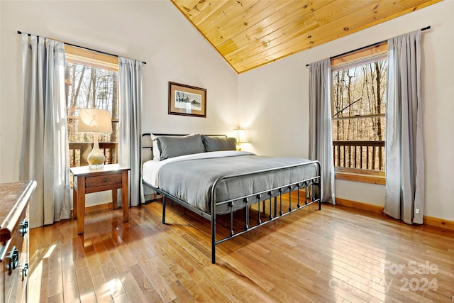 bedroom featuring light hardwood / wood-style flooring, wood ceiling, and high vaulted ceiling