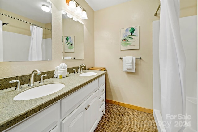 bathroom with double vanity and tile patterned flooring