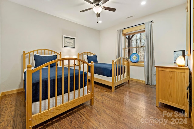 bedroom featuring dark wood-type flooring and ceiling fan