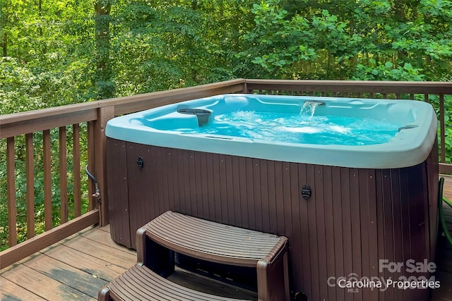 view of swimming pool with a deck and a hot tub