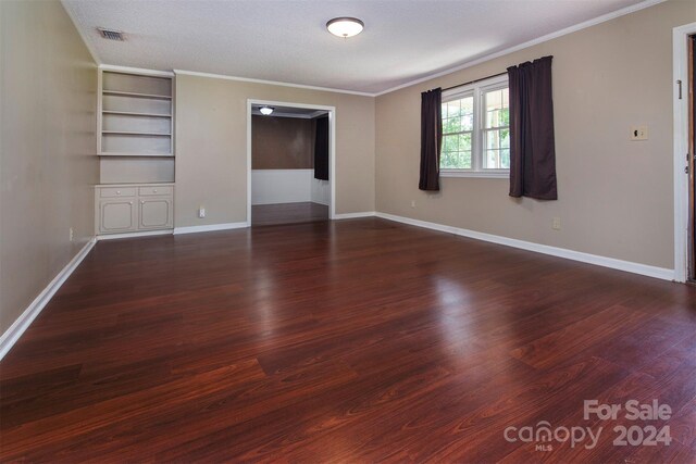 unfurnished bedroom with a textured ceiling, dark hardwood / wood-style floors, and crown molding