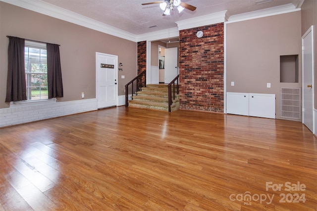 unfurnished living room with light wood-style floors, visible vents, and crown molding