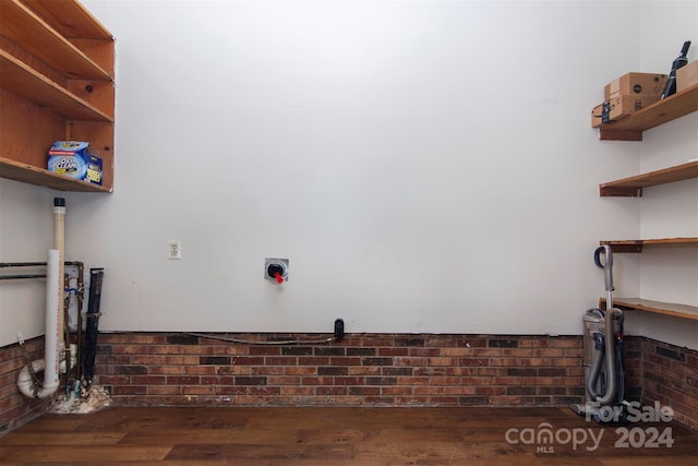 laundry area with wood finished floors