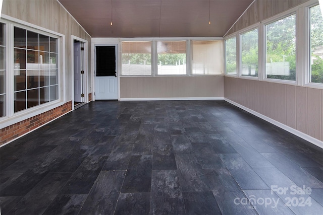 unfurnished sunroom with vaulted ceiling