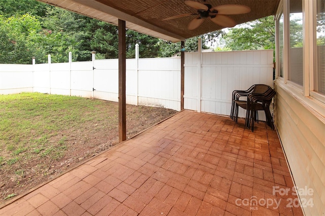 view of patio / terrace featuring ceiling fan and fence