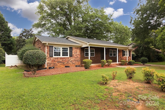 single story home featuring brick siding, a shingled roof, crawl space, fence, and a front yard