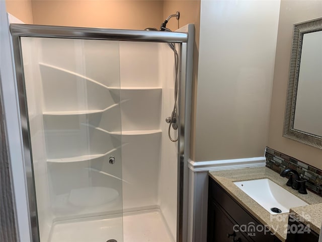 bathroom with a stall shower and vanity