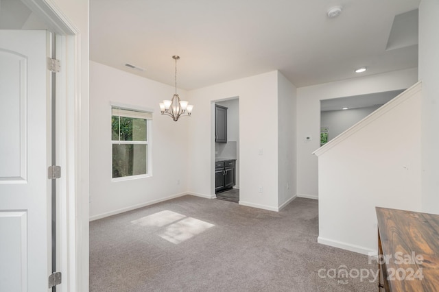 unfurnished room with a notable chandelier and carpet flooring