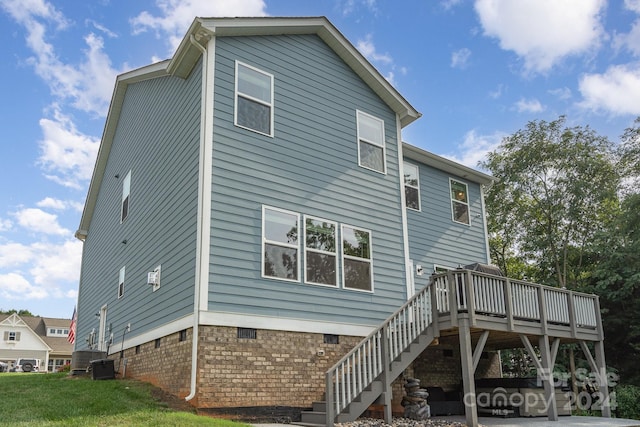 back of property with central AC and a wooden deck