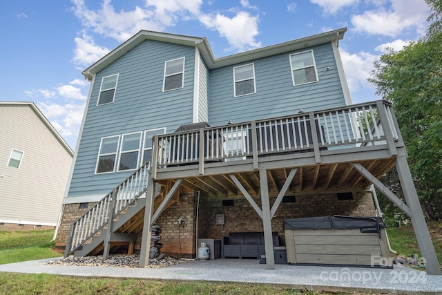 rear view of property featuring a patio and a deck