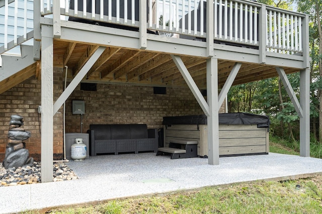 view of patio / terrace with a wooden deck and a hot tub