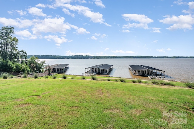 view of dock featuring a water view and a yard