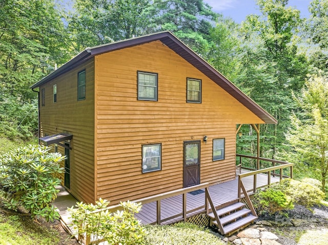 view of home's exterior with a wooden deck