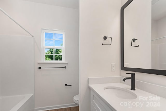 full bathroom with shower / tub combination, toilet, vanity, and hardwood / wood-style flooring