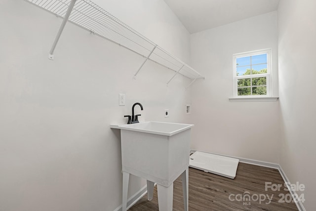 clothes washing area with electric dryer hookup, dark wood-type flooring, and washer hookup