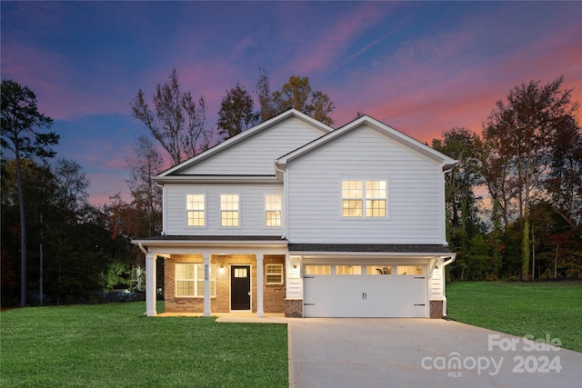 view of front of home with a lawn and a garage