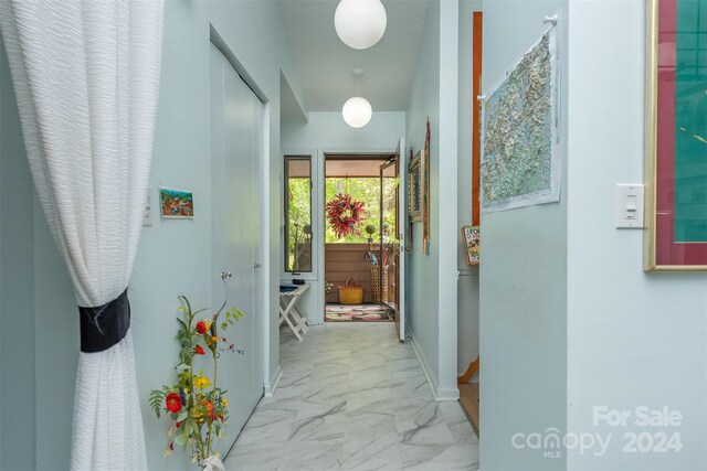 hall with tile patterned flooring