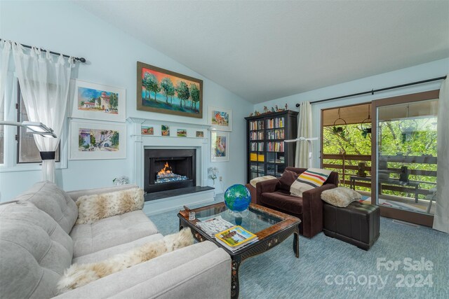 carpeted living room with lofted ceiling