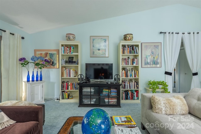 carpeted living room with lofted ceiling and a fireplace