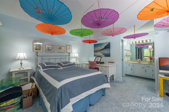 bedroom featuring ensuite bathroom and light colored carpet