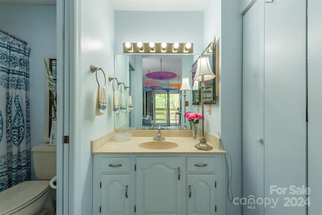 full bath featuring vanity and toilet