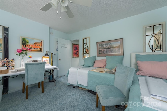 bedroom with a ceiling fan, carpet, and a textured ceiling