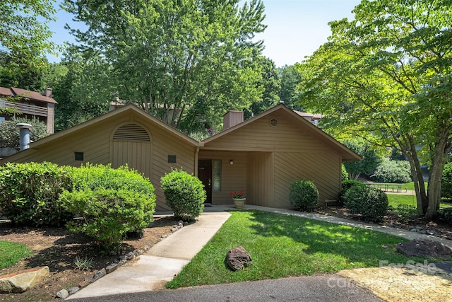 view of front of property with a front yard and a chimney