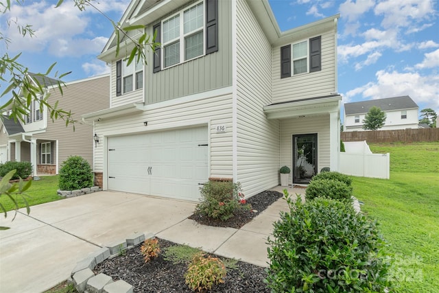 view of front of house with a garage and a front lawn