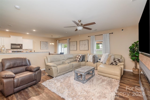 living room with dark hardwood / wood-style floors and ceiling fan