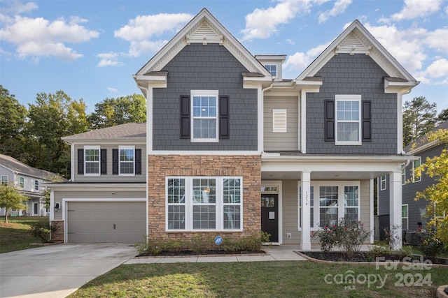 craftsman-style house featuring a front yard and a garage