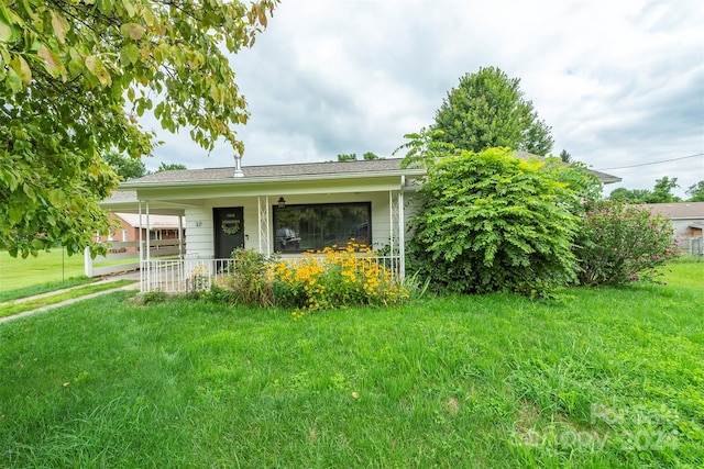 exterior space featuring covered porch and a lawn