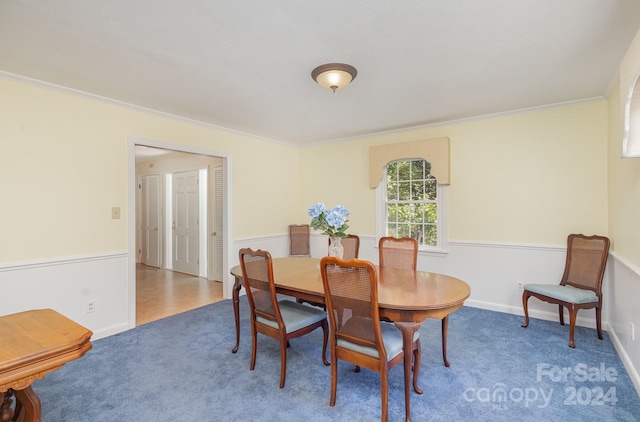 dining area with carpet flooring and ornamental molding