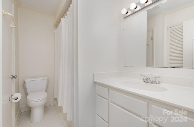 bathroom featuring tile patterned flooring, toilet, vanity, and ornamental molding