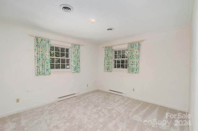 unfurnished room featuring a baseboard radiator and carpet floors