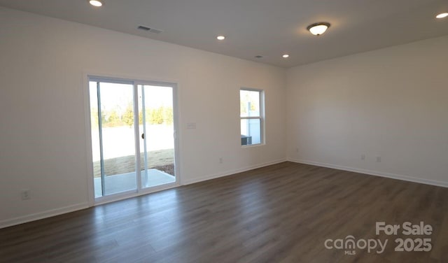 empty room with dark wood-type flooring