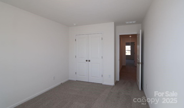 unfurnished bedroom with carpet floors and a closet