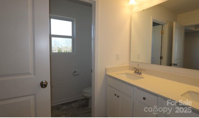 bathroom featuring vanity and toilet