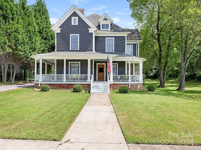 view of front of property with covered porch and a front lawn