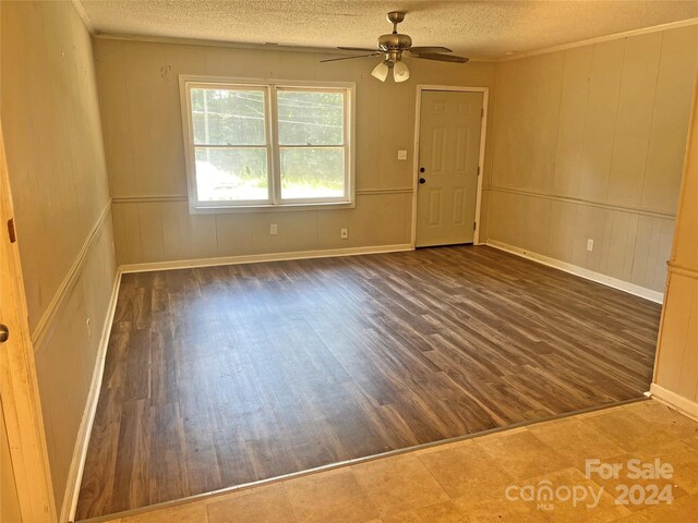 unfurnished room with hardwood / wood-style floors, ceiling fan, and a textured ceiling