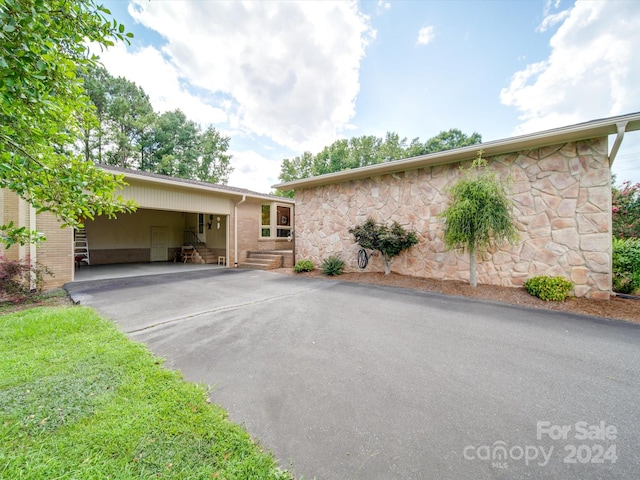 ranch-style home featuring a carport