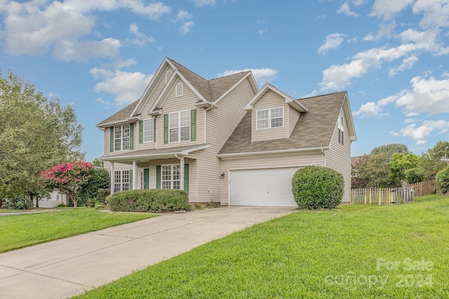 view of front of property featuring a garage and a front yard