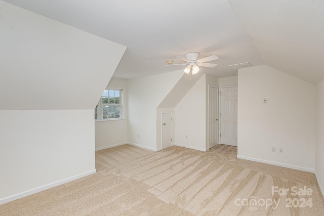 bonus room with vaulted ceiling, light carpet, and ceiling fan